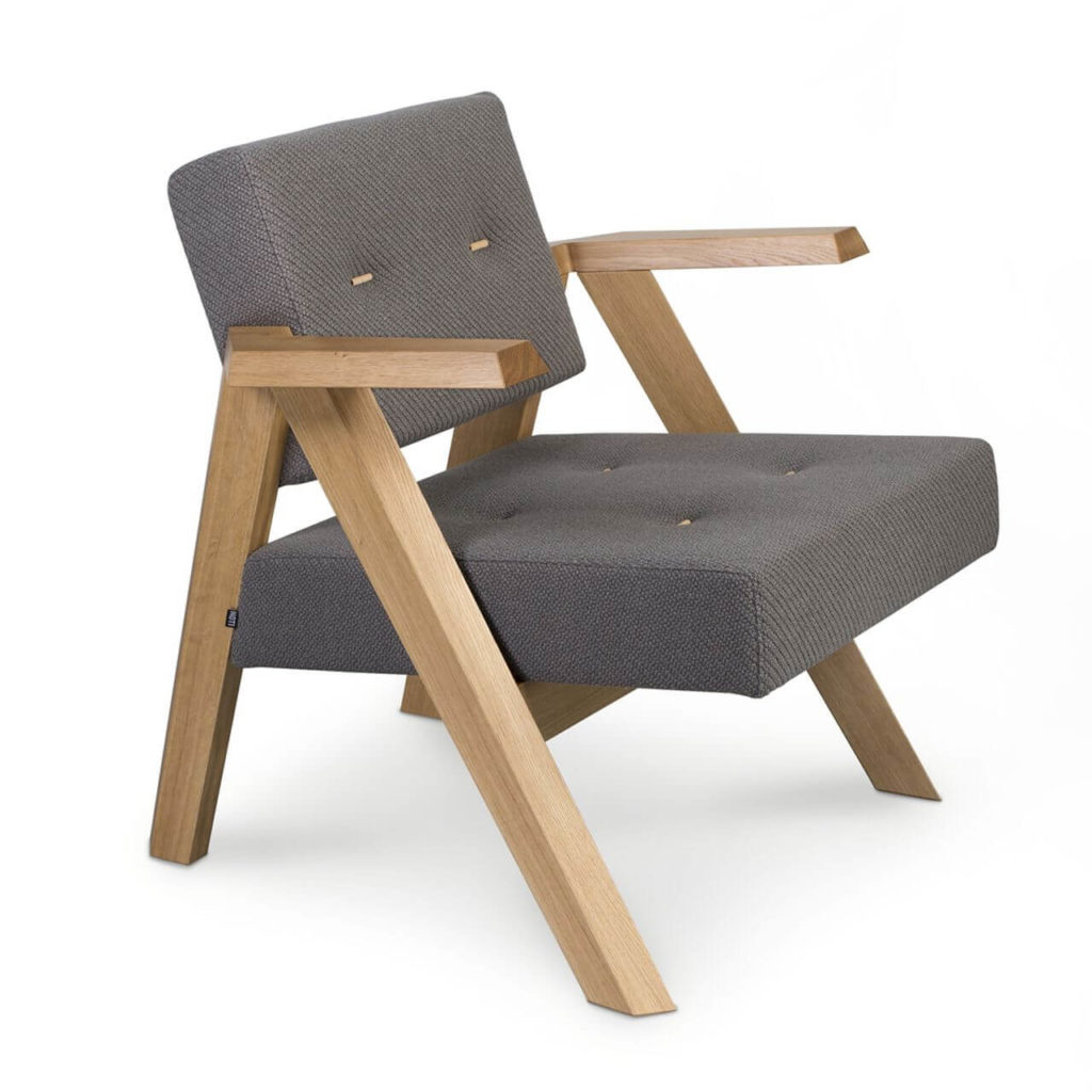 A wooden armchair with simple, square shapes. Its legs are wooden, backrest and seat are made of black soft fluffy fabric.
