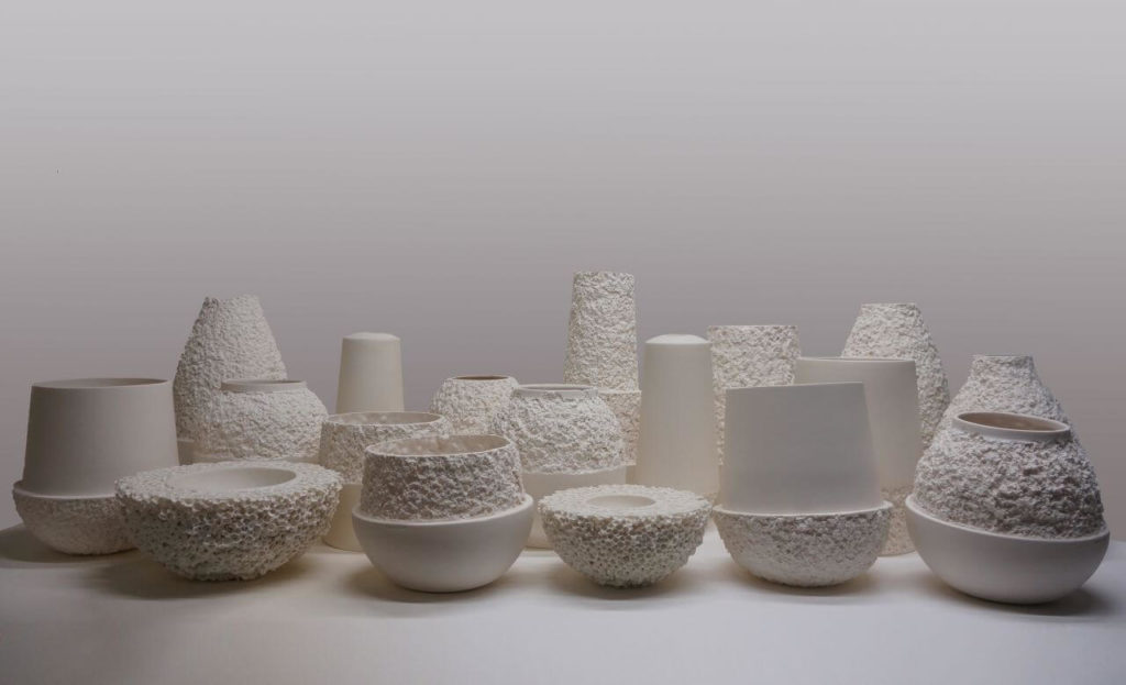 A set of 18 ceramic vases. They come in a variety of shapes. The majority of jars have smooth spherical bases and porous conical tops of varied heights.