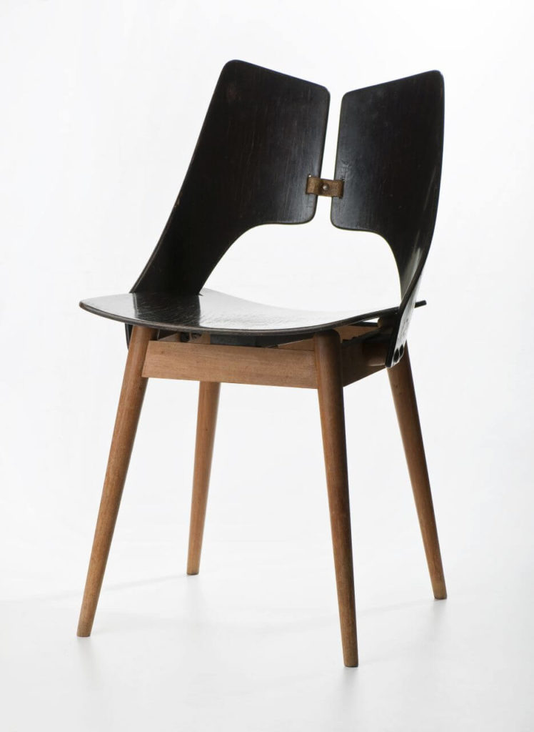 A wooden chair Its legs are light-brown, while the seat and a lungs-shaped two-part backrest are black.