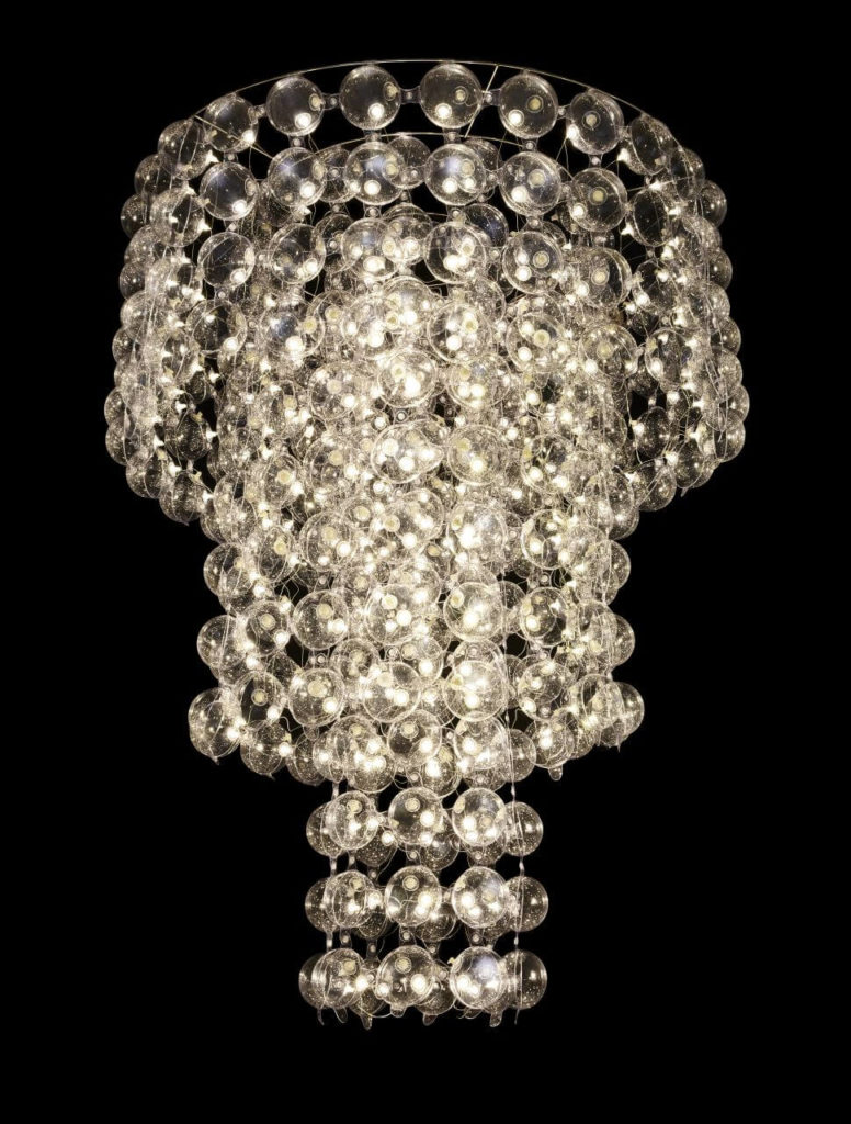A chandelier, which is a hanging structure consisting of dozens of round objects made of PVC, with a hidden LED inside. The central part of the chandelier is the longest, so it hangs lower than the parts surrounding it.