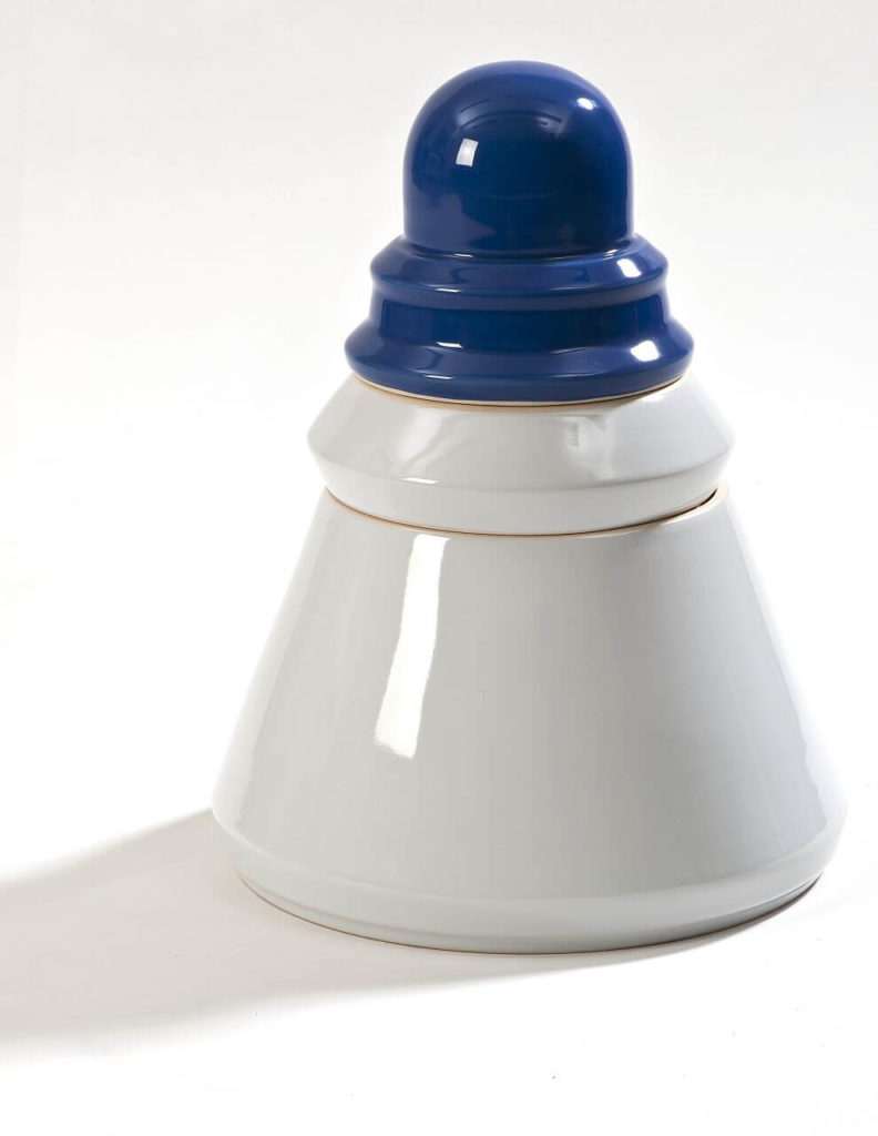 A pyramid-shaped white ceramic vessel with a rounded blue tip.